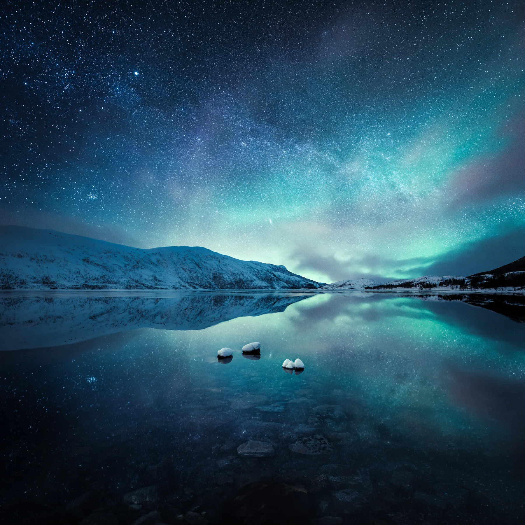 A shipwreck on still water beneath a star-filled night sky in an atmospheric coastal landscape by Mikko Lagerstedt