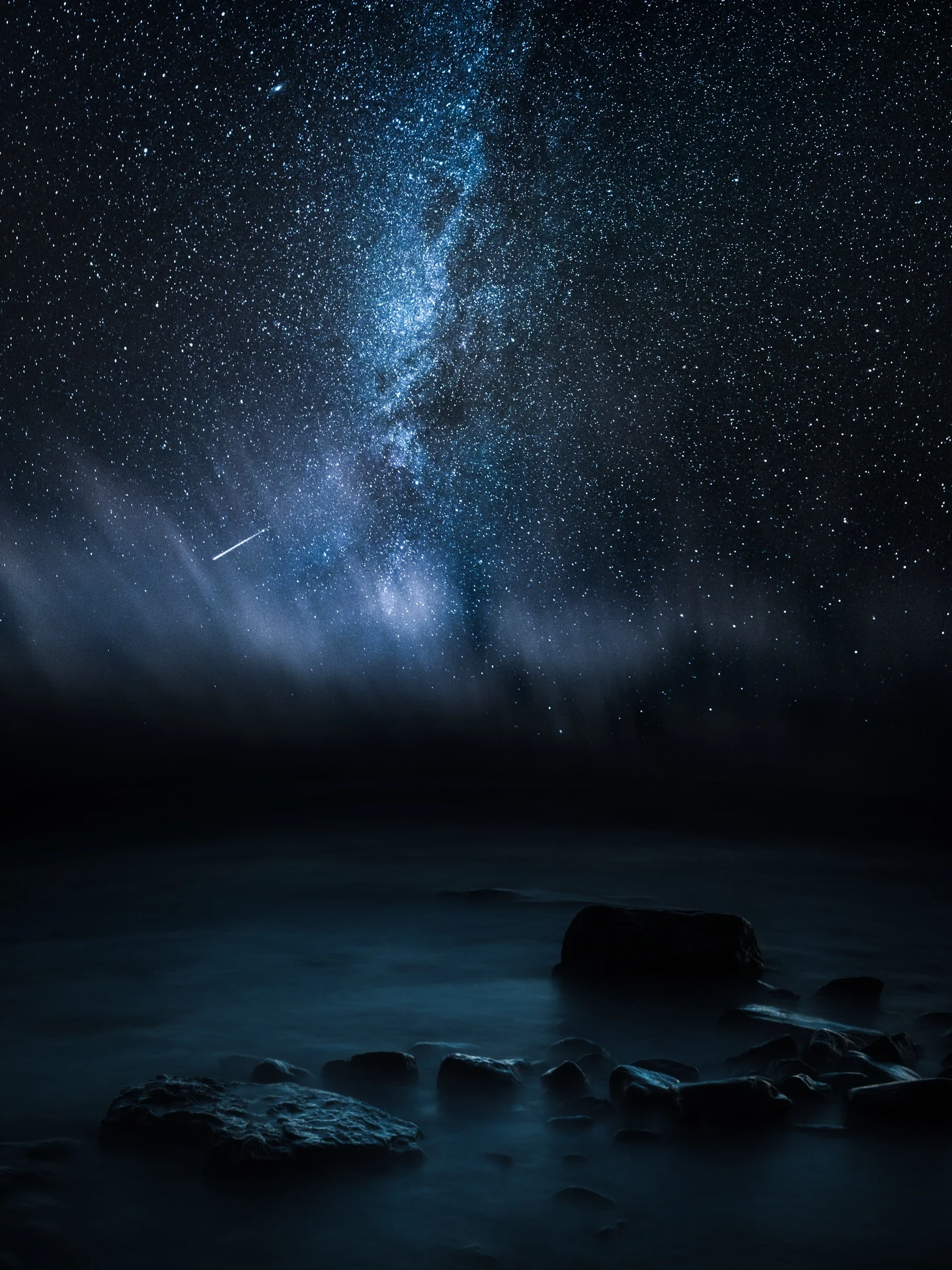 Milky Way rising above a quiet dark seascape