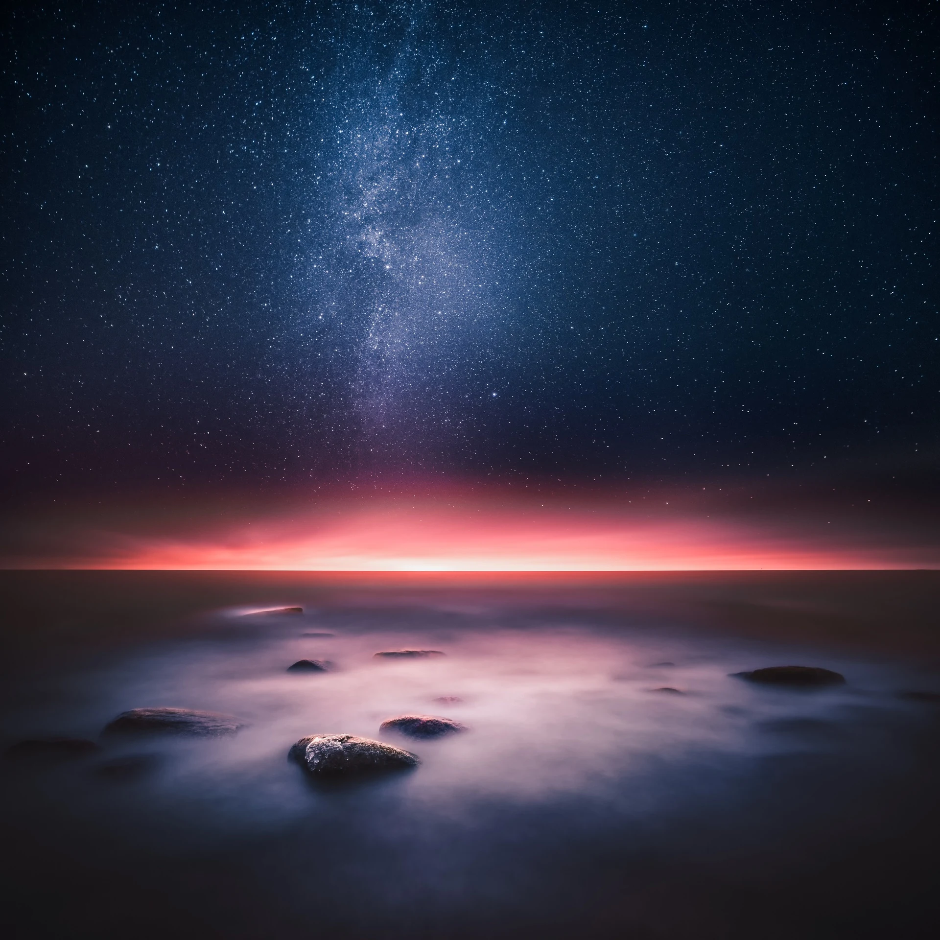 Dreamlike twilight sky fading into night above still water
