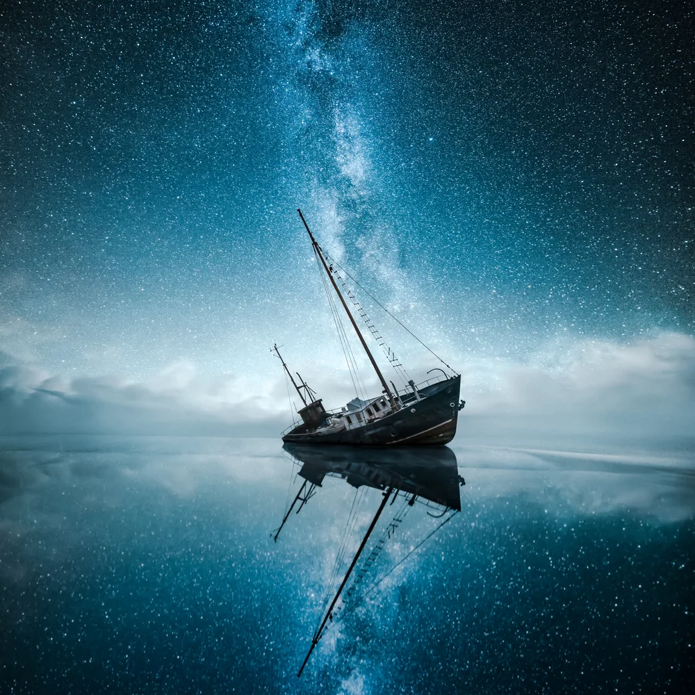 Shipwreck beneath the Milky Way in a still night seascape