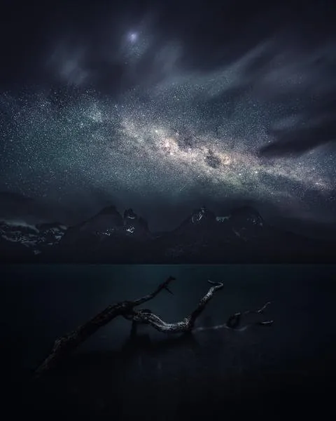 Milky Way above dark Patagonian mountains and water from the Patagonia gallery by Mikko Lagerstedt